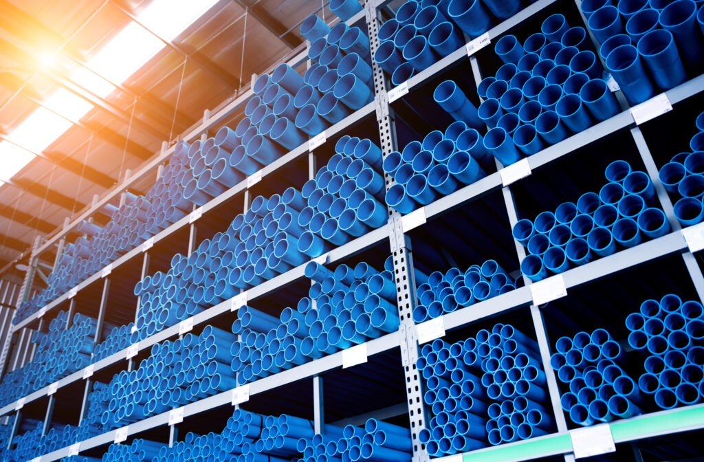 blue plastic pipes in a stack in a large warehouse of a shopping center blue plastic pipes in a stack in a large warehouse of a shopping center