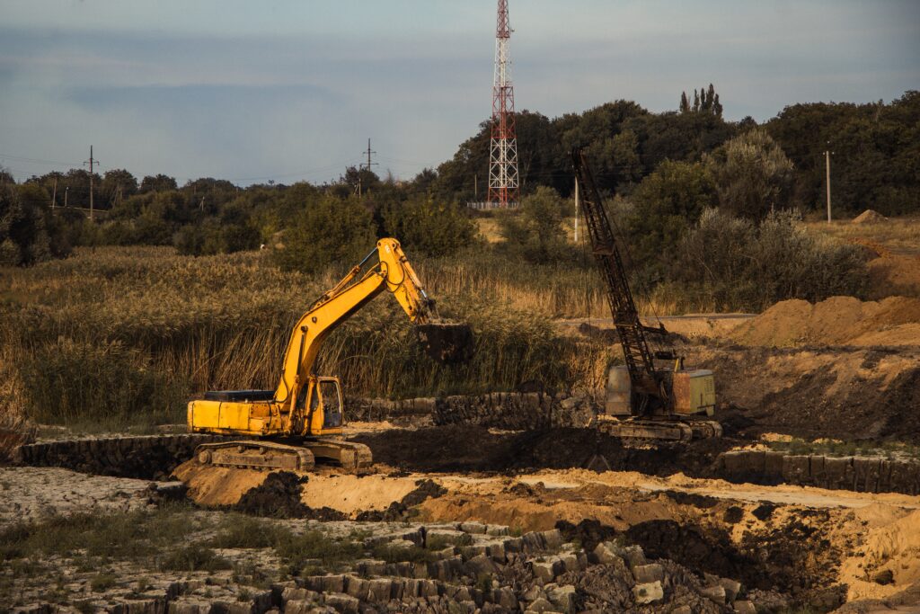 closeup shot of an ongoing construction with tracks and a bulldozer on an abandoned land closeup shot of an ongoing construction with tracks and a bulldozer on an abandoned land