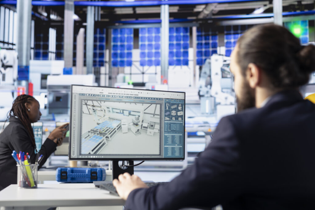 solar panels plant engineer looking over assembly lines blueprints on pc screen solar panels plant engineer looking over assembly lines blueprints on pc screen